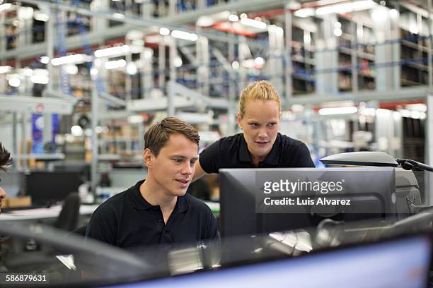 employees using computer in logistics warehouse - freight transportation stock-fotos und bilder