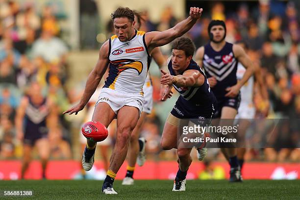 Mark Hutchings of the Eagles passes the ball during the round 20 AFL match between the Fremantle Dockers and the West Coast Eagles at Domain Stadium...