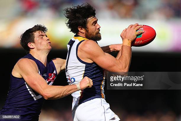 Josh Kennedy of the Eagles marks the ball against Sam Collins of the Dockers during the round 20 AFL match between the Fremantle Dockers and the West...
