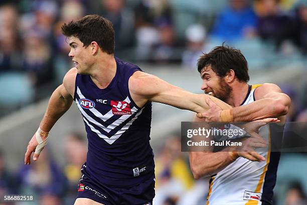 Sam Collins of the Dockers attempt to block Josh Kennedy of the Eagles from a contest during the round 20 AFL match between the Fremantle Dockers and...