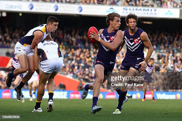 Tommy Sheridan of the Dockers runs with the ball during the round 20 AFL match between the Fremantle Dockers and the West Coast Eagles at Domain...