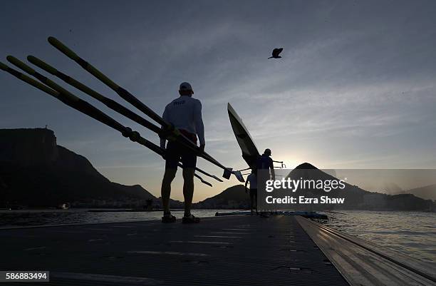 The Russian men's four bring their boat to the water to warm up prior to the rowing on Day 2 of the Rio 2016 Olympic Games at the Lagoa Stadium on...