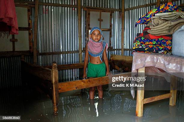 Little child stands in the floodwater at Kurigram. Bangladesh has been suffering from devastating monsoon floods from the middle of July. Causes of...