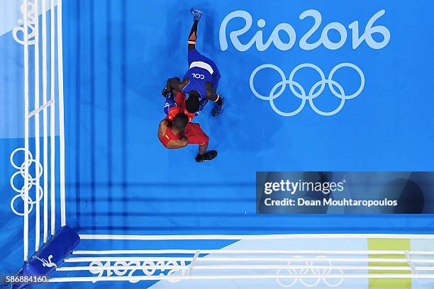 Patrick Lourenco of Brazil and Yurberjen Herney Martinez of Colombia compete in their Men's Light Fly 46-49kg Preliminary bout on Day 1 of the Rio...