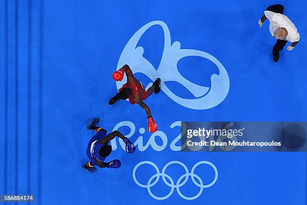 Patrick Lourenco of Brazil and Yurberjen Herney Martinez of Colombia compete in their Men's Light Fly 46-49kg Preliminary bout on Day 1 of the Rio...