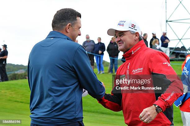 Anthony Wall of England is congratulated by tournament host Paul Lawrie of Scotland after his win in the final match on day four of the Aberdeen...