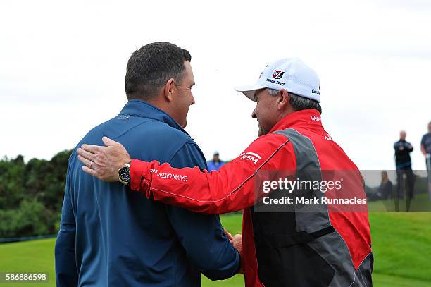 Anthony Wall of England is congratulated by tournament host Paul Lawrie of Scotland after his win in the final match on day four of the Aberdeen...