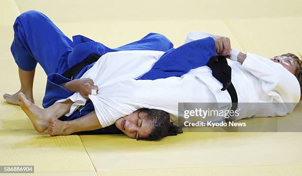 London Olympics gold medalist Sarah Menezes of Brazil is overpowered by Urantsetseg Munkhbat of Mongolia during the women's 48-kilogram judo event at...