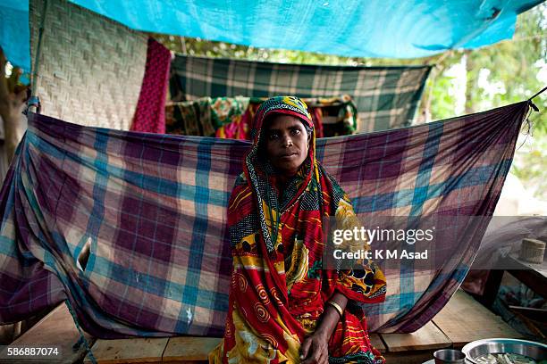 After being washed out and having lost their houses by the floodwater people take shelter on a water dam at Fulchori, Gaibandha. Bangladesh has been...