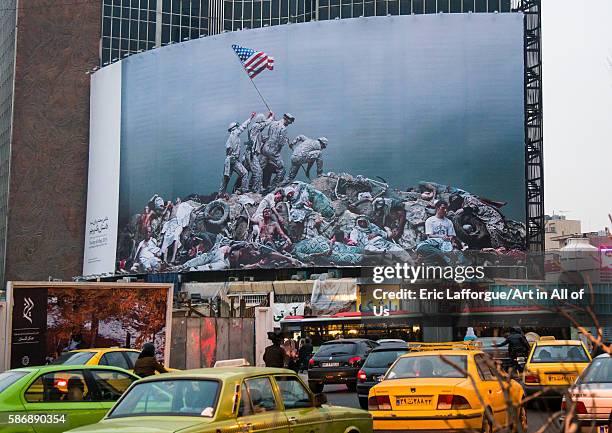 Parody of raising the flag on iwo jima historic picture on valiasr square showing american marines on dead bodies, central district, tehran, Iran on...