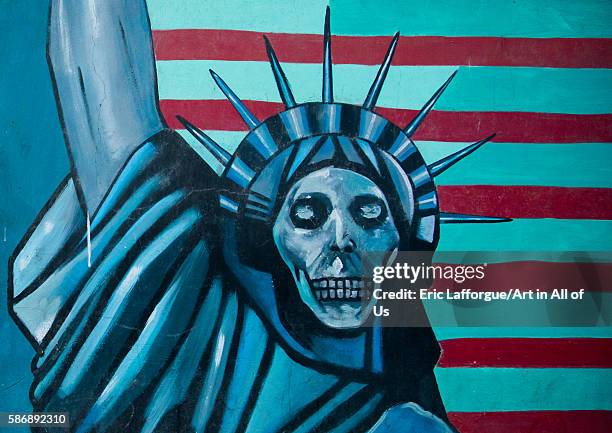Anti-american mural propoganda slogan depict statue liberty skeleton on the wall of the former united states embassy, central district, tehran, Iran...