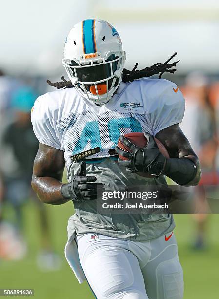 Marqueis Gray of the Miami Dolphins runs with the ball during the teams training camp on August 5, 2016 at the Miami Dolphins training facility in...