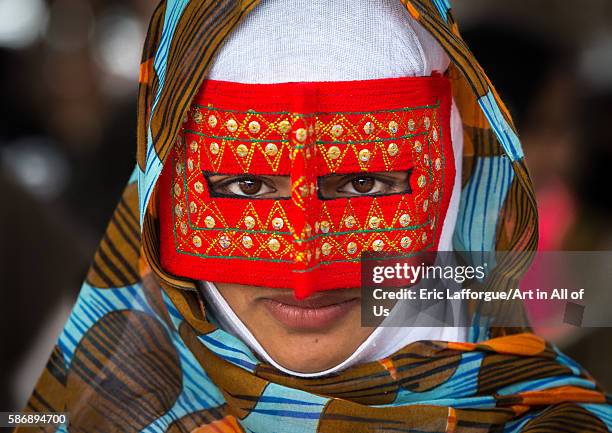 Abandari woman wearing a traditional mask called the burqa at panjshambe bazar thursday market, hormozgan, minab, Iran on December 31, 2015 in Minab,...