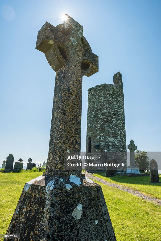 Old Kilcullen (Cill Chuilinn), County Kildare, Leinster province, Ireland, Europe. Decorated High Cross and Round Tower in the old historic graveyard.