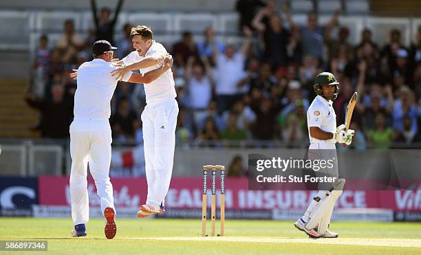 England bowler Chris Woakes celebrates with Stuart Broad after dismissing Asad Shafiq during day 5 of the 3rd Investec Test match between England and...