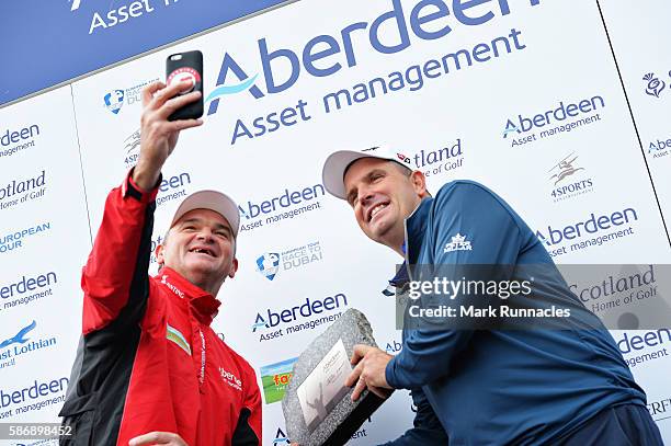 Anthony Wall of England gets a selfie with his winners trophy and tournament host Paul Lawrie of Scotland on day four of the Aberdeen Asset...