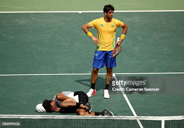 Dustin Brown of Germany hurts his ankle during his match against Thomaz Bellucci of Brazil in their first round match on Day 2 of the Rio 2016...