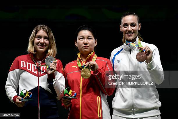 Silver medallist Russia's Vitalina Batsarashkina, gold medal winner China's Zhang Mengxue and bronze medallist Greece's Anna Korakaki stand on the...