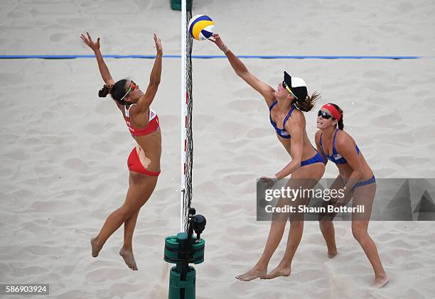 Kinga Kolosinska of Poland in action against Lauren Fendrick and Brooke Sweat of the United States during the Women's Beach Volleyball preliminary...