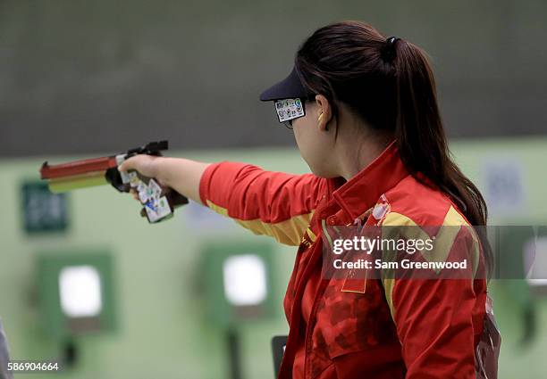 Mengxue Zhang of China competes during the Women's 10m Air Pistol qualifying event during the shooting competition on Day 2 of the Rio 2016 Olympic...