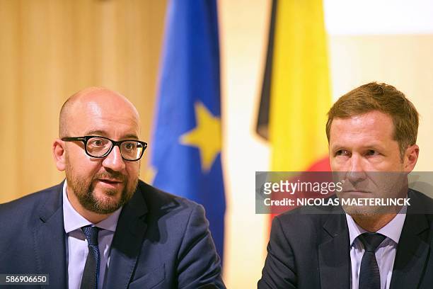 Belgian Prime Minister Charles Michel flanked by Charleroi's mayor Paul Magnette speaks during a press conference at the police headquarters on...