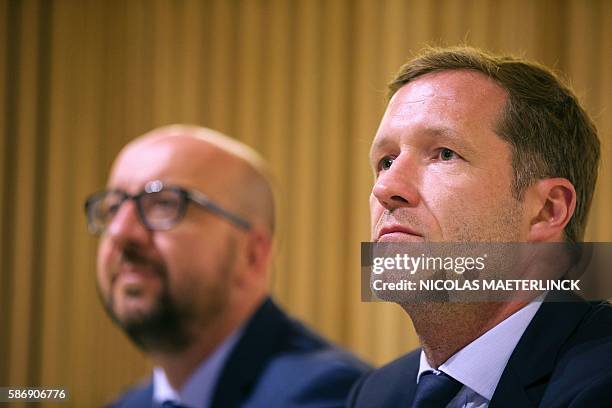 Charleroi's mayor Paul Magnette flanked by Belgian Prime Minister Charles Michel looks on during a press conference at the police headquarters on...