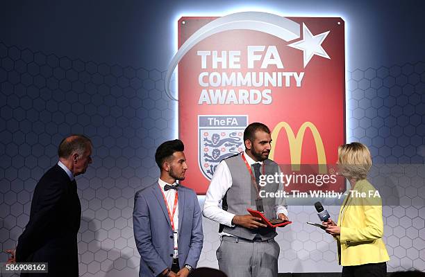 Jacqui Oatley on stage with the winners of the FA Charter Standard Club Award, Alpha United Juniors at the McDonalds Community Awards at Wembley...