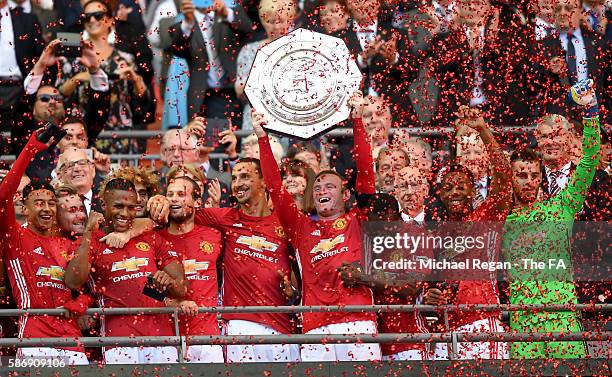 Wayne Rooney of Manchester United lifts the Community Shield Trophy after his side won two one during The FA Community Shield match between Leicester...
