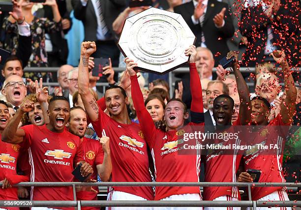 Wayne Rooney of Manchester United and Zlatan Ibrahimovic of Manchester United lift the trophy and celebreate with their team mates after the final...