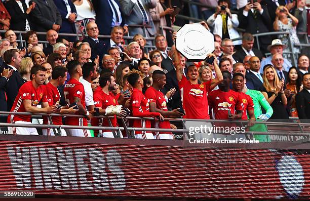 Zlatan Ibrahimovic of Manchester United celebrates with his team mates after he lifts the Community Shield during The FA Community Shield match...