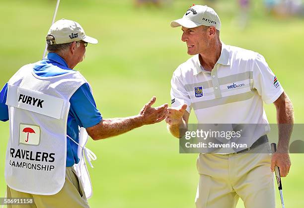 Jim Furyk of the United States celebrates with his caddie Mike "Fluff" Cowan after a shooting a record setting 58 during the final round of the...