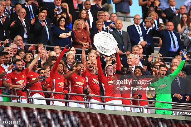 Wayne Rooney of Manchester United lifts the Community Shield after the final whistle during The FA Community Shield match between Leicester City and...
