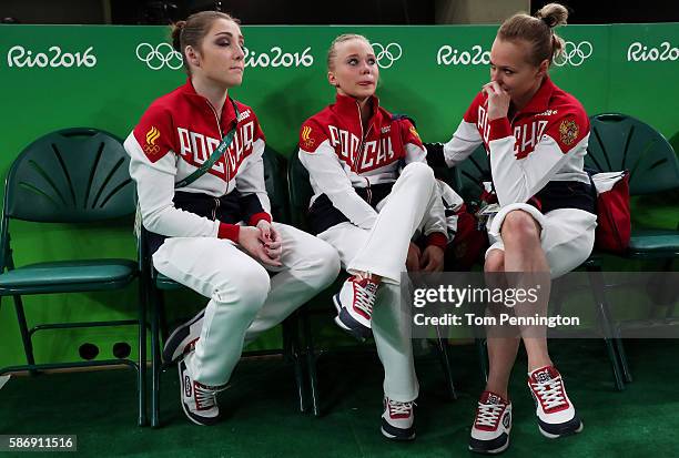 Angelina Melnikova of Russia shows her emotion while Aliya Mustafina and Daria Spiridonova console after Women's qualification for Artistic...
