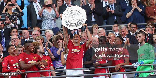 Zlatan Ibrahimovic of Manchester United lifts the Community Shield trophy after the FA Community Shield match between Leicester City and Manchester...