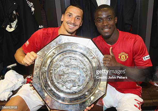 Zlatan Ibrahimovic and Eric Bailly of Manchester United pose with the Community Shield trophy in the dressing room after the FA Community Shield...