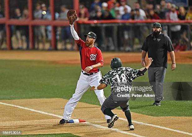 First basemen Adam LaRoche of the Kansas Stars reaches for the ball to force out base runner Eduardo Sanchez of the Colorado Xpress at first base, in...