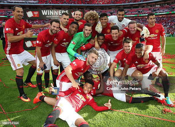 The Manchester United squad pose with the Community Shield trophy after the FA Community Shield match between Leicester City and Manchester United at...