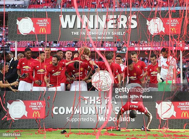 The Manchester United squad pose with the Community Shield trophy after the FA Community Shield match between Leicester City and Manchester United at...