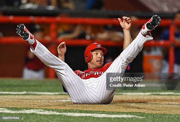 Base runner Pete Orr of the Kansas Stars rolls onto his back after scoring a run against the Colorado Xpress in the seventh inning during the NBC...