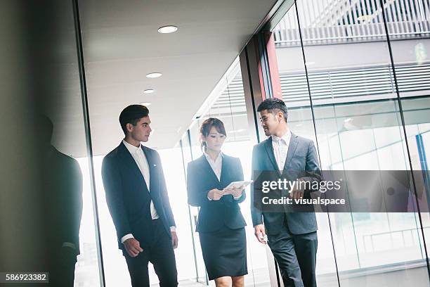 three entrepreneurs briefing in the office - meeting candid office suit stock pictures, royalty-free photos & images