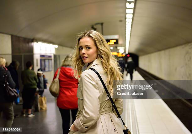 blonde swedish woman walking along commuter subway train platform - stockholm stock pictures, royalty-free photos & images