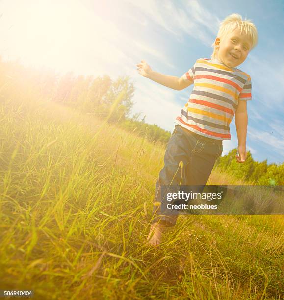 boy running along the path - one boy stock pictures, royalty-free photos & images