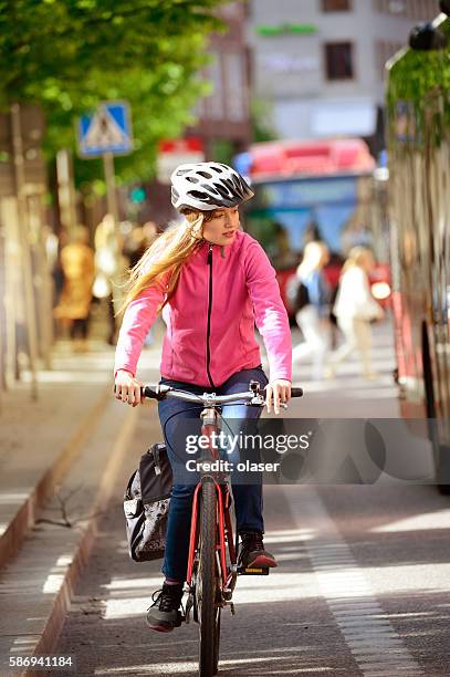 swedish girl and bicycle in traffic - bicycle safety light stockfoto's en -beelden