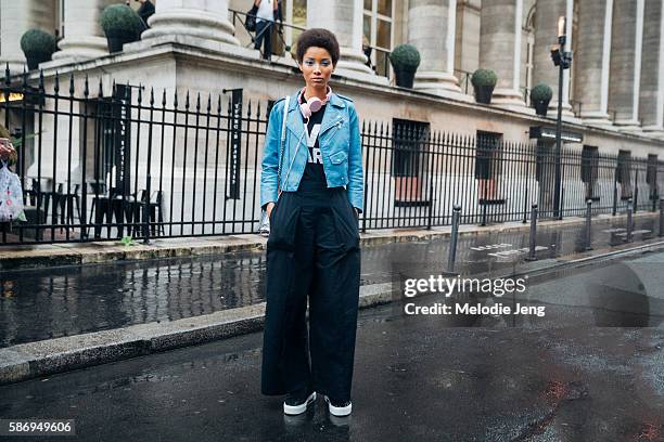 Dominican model Lineisy Montero keeps the blue eyeliner by Pat McGrath and wears pink headphones, a cropped blue leather jacket, and wide-legged...