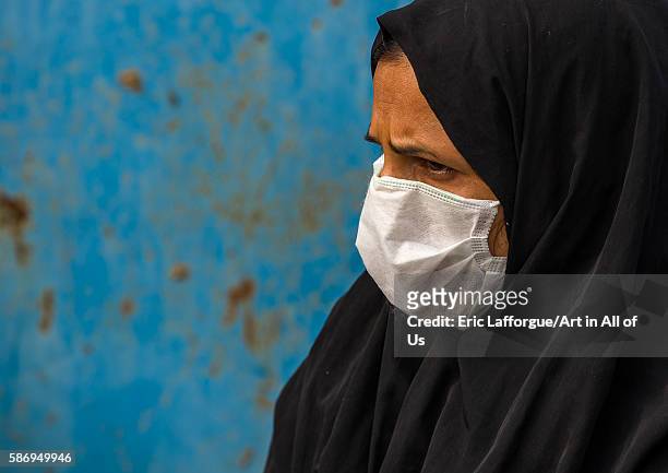 Awoman wearing a face mask to protect from h1n1 influenza in panjshambe bazar, hormozgan, minab, Iran on December 31, 2015 in Minab, Iran.