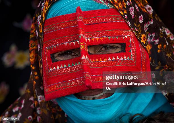 Abandari woman wearing a traditional mask called the burqa at panjshambe bazar thursday market, hormozgan, minab, Iran on December 31, 2015 in Minab,...