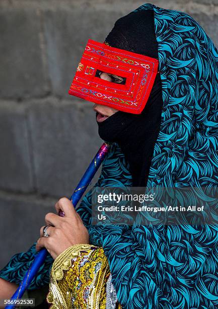 Abandari woman wearing a traditional mask called the burqa at panjshambe bazar thursday market, hormozgan, minab, Iran on December 31, 2015 in Minab,...