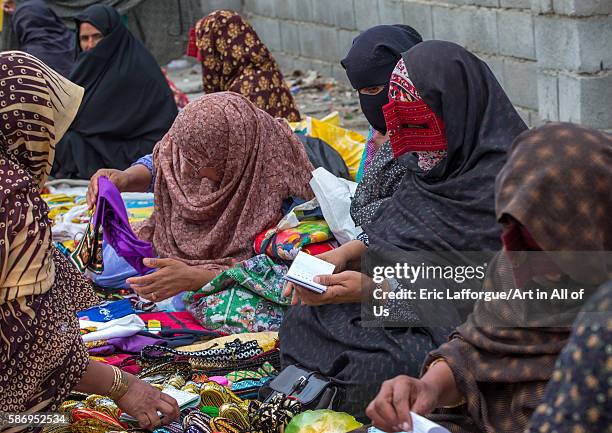 Abandari woman wearing a traditional mask called the burqa at panjshambe bazar thursday market, hormozgan, minab, Iran on December 31, 2015 in Minab,...