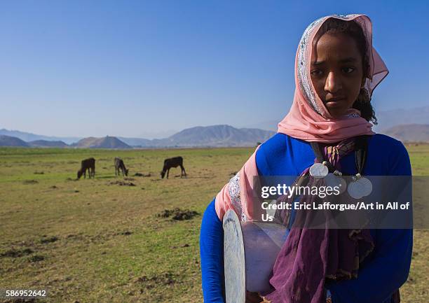 Portrait of an oromo girl with maria theresa thalers necklace, amhara region, artuma, Ethiopia on February 21, 2016 in Artuma, Ethiopia.