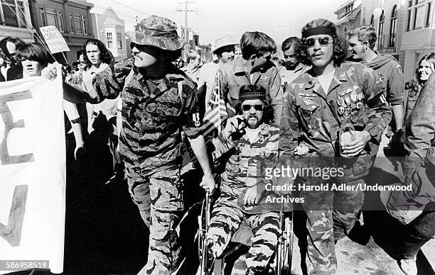 An anti-Vietnam War peace march with Vietnam vets, one an amputee in a wheelchair, leading the way, San Francisco, California, 1970.